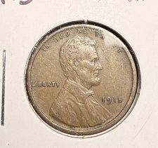 1915 wheat penny die cud error showing raised mass of metal at the rim